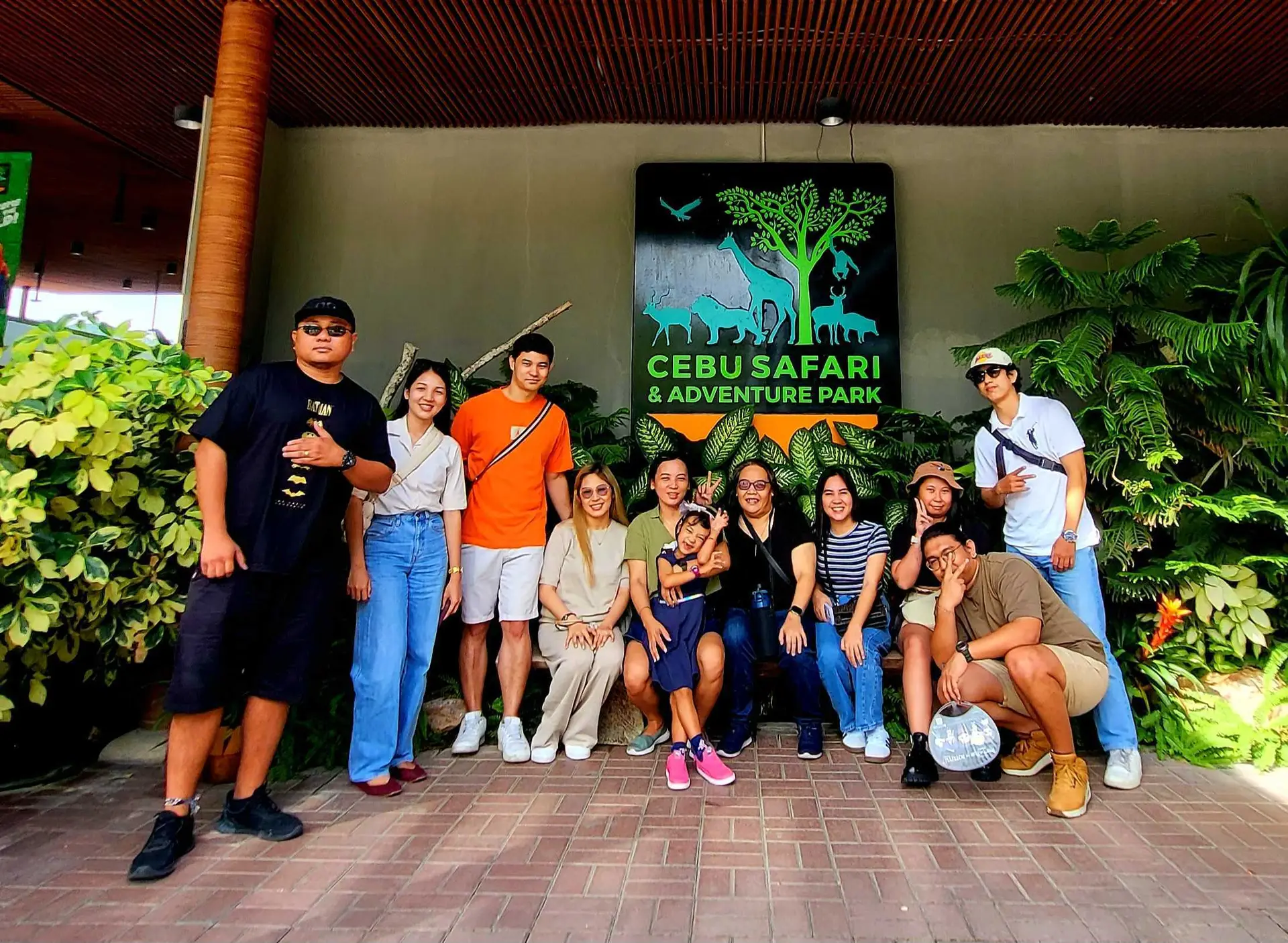 The Open Door Capital International Team Members posing in front of a Safari Park sign.